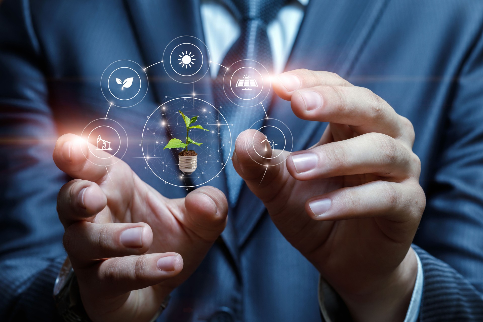 Businessman hands interact with alternative energy sources on blurred background.